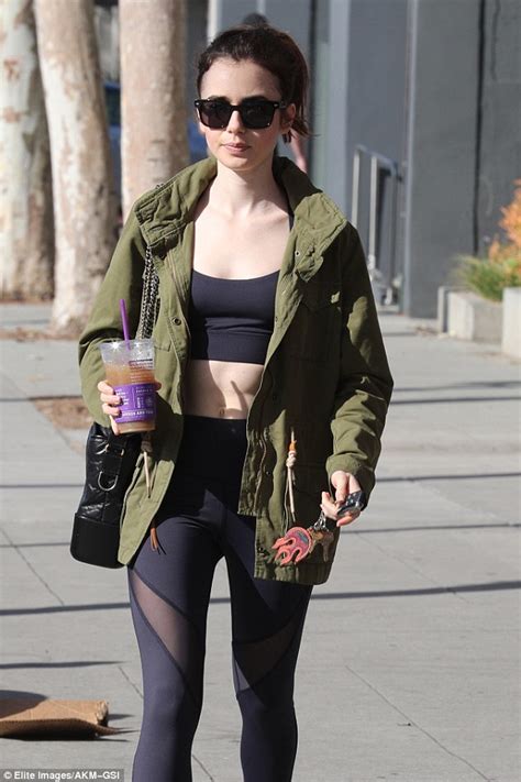 Lily Collins Flaunts Her Taut Tummy In Sports Bra Daily Mail Online