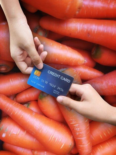 Premium Photo Spending Buying Vegetables Carrots Paying By Credit Card