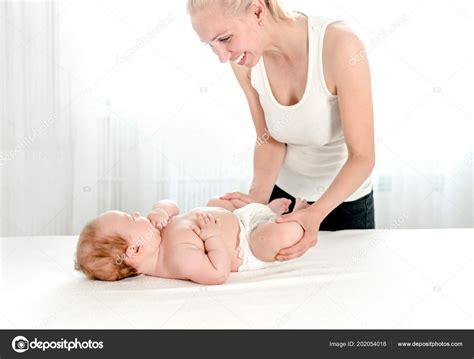 Mother Massaging Her Infant Baby Stock Photo Tan Ikk
