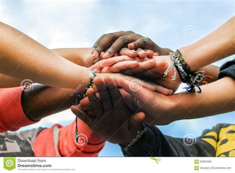 Multiracial Teen Friends Joining Hands Together In Cooperation Stock
