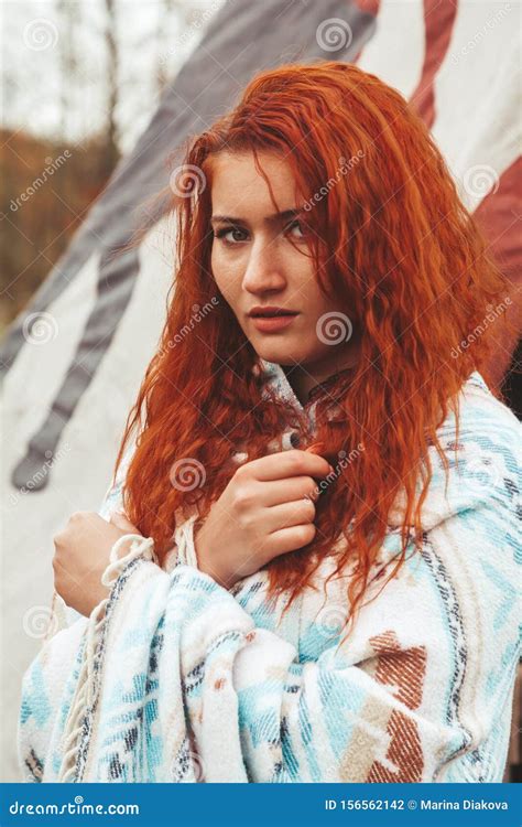 Redhead Modern Girl Near Native American TeePee Campsite Stock Photo