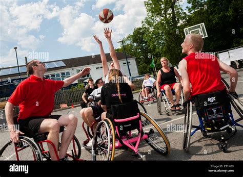 Teams Of Able Bodied And Disabled People Playing Wheelchair Basketball