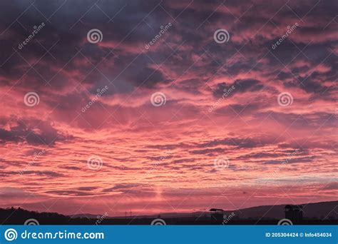 A Deep Purple Sunset With Dark Clouds In The Morning Stock Photo