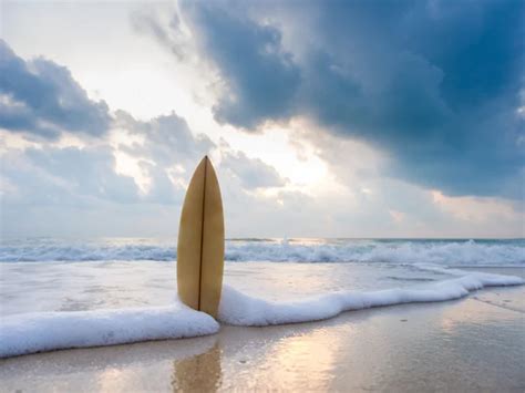Surfboard On The Beach At Sunset Stock Photo By ©netfalls 61632579