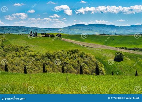 Tuscany Spring Rolling Hills And Windmill On Sunset Stock Image