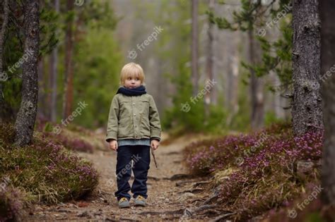 Premium Photo Cute Little Boy Walks In Swiss National Park On Spring