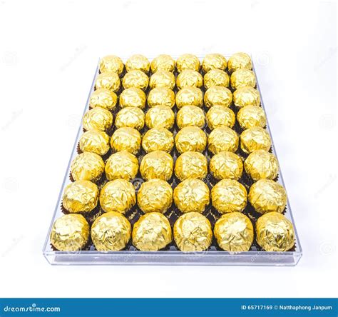 A Lot Of Shiny Golden Chocolate Wrapper In Line On White Background