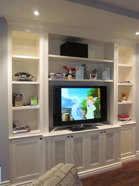 A Flat Screen Tv Sitting On Top Of A White Entertainment Center