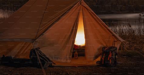 A Tent With A Fire Burning Inside Of It Photo Night Camping Image On
