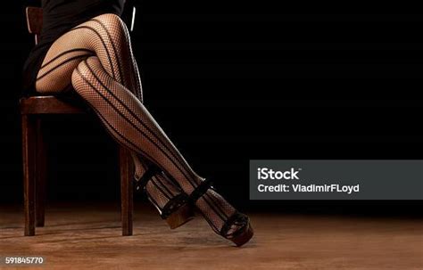 Feminine Crossed Legs In Fishnet Stockings Stock Photo Download Image