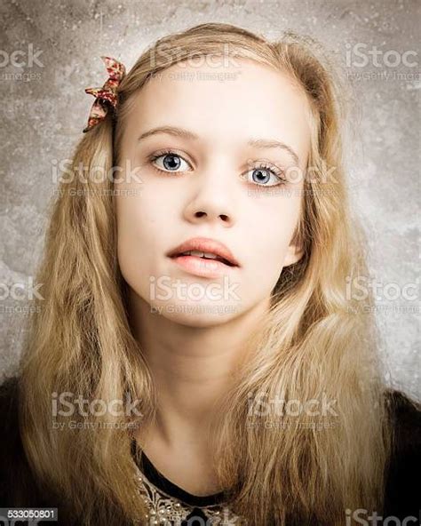 Beautiful Blond Teenage Girl Looking In The Camera Stock Photo