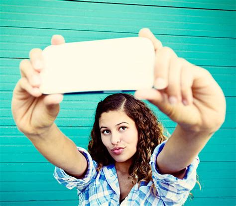 50 Blonde Female Teenager Pouting For Selfie Picture On Mobile Phone