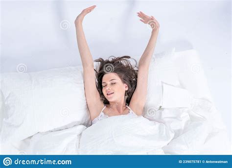 Wellness Concept A Young Beautiful Brunette Woman Wakes Up In Her Bed Fully Rested Stock Image