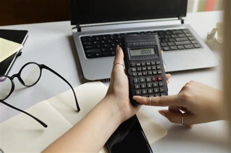 A Female Accountant Calculates On A Calculator Stock Photo Image Of
