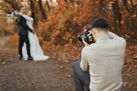 Wedding Photographer Taking Pictures Of The Bride And Groom Stock Image