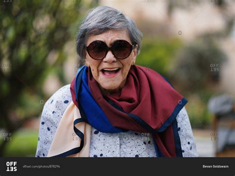 Portrait Of Happy Old Woman Laughing Wearing Sunglasses