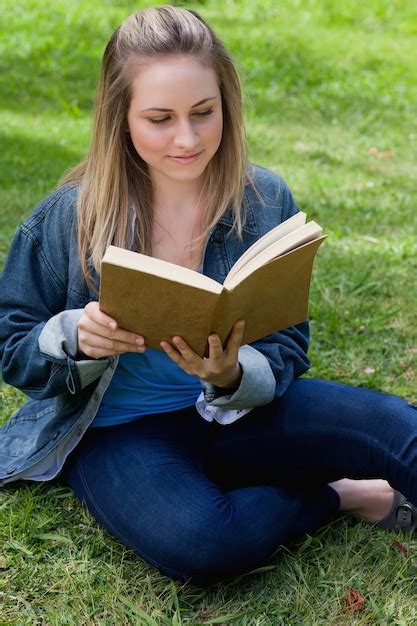 Premium Photo Young Relaxed Girl Reading A Book While Sitting On The