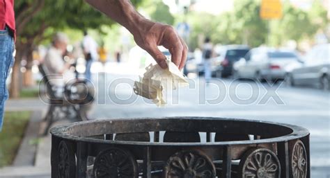 Man Throwing Garbage In A Trash Bin Stock Image Colourbox