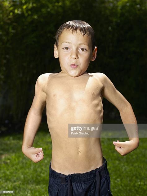 Boy Showing Muscles Foto Stock Getty Images