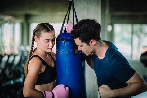 Fit Beautiful Woman Boxer Hitting A Huge Punching Bag Exercise Class In