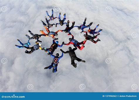 Formation Skydivinga Big Group Of Skydivers Is In The Sky Above White