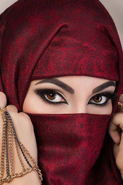 Portrait Of Beautiful Arabian Girl Hiding Her Face Behind Red Niqab
