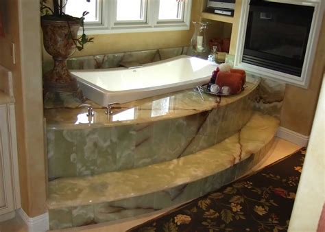 Traditional bathroom with white onyx tile and white furniture. Onyx Marble Bathroom | MilleStone Marble & Tile