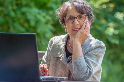 Mature Brunette Using Laptop In The Garden Stock Image Image Of Technology Outside