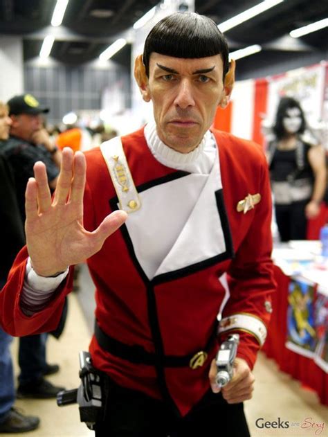 A Man Dressed Up As Star Trek Spock Holding His Hand Out To The Camera
