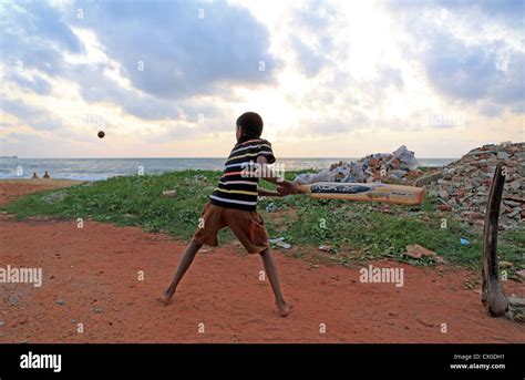 Young Sri Lankan Boy Playing Cricket On The Beach At Negombo Sri Lanka
