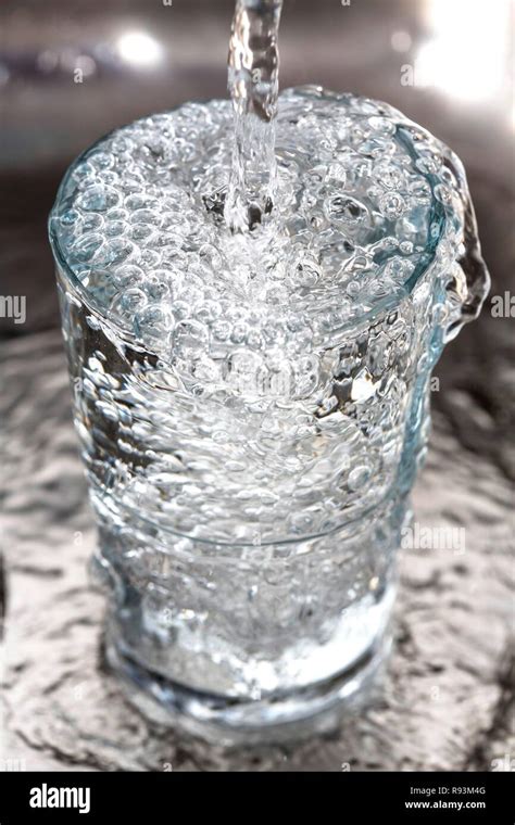 Water Overflowing In A Glass Stock Photo Alamy