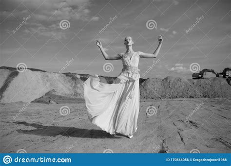 Splendid Young Blonde Model Woman In The Desert In Long