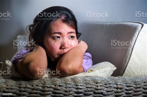 Young Sad And Depressed Asian Korean Woman At Home Sofa Couch Crying