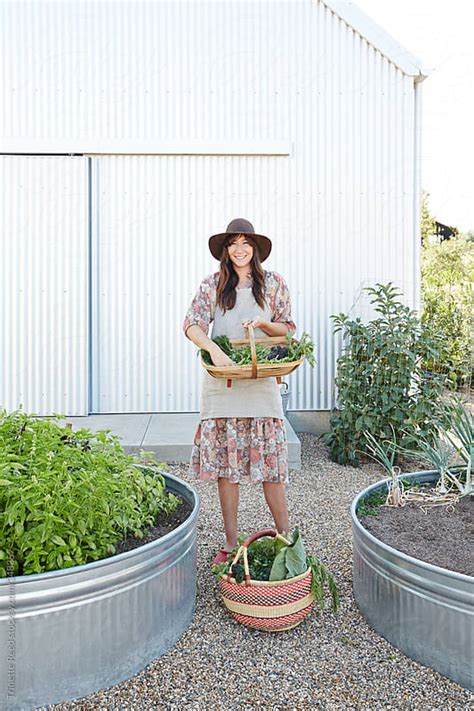 Woman Gardening In Her Backyard Vegetable Garden By Trinette Reed