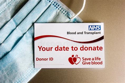 Nhs Blood And Transplant Donor Card And A Medical Mask Editorial