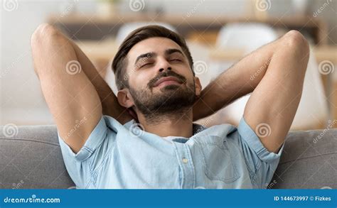 Calm Peaceful Man Relaxing With Closed Eyes Leaning Back On Sofa Stock