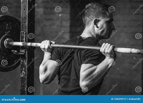 A Nice Muscular Guy With A Strong Body Exercises At The Gym