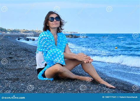 Middle Aged Woman Sitting On Sea Beach Traveling Happy Resting Female Looks At Sea Stock Image