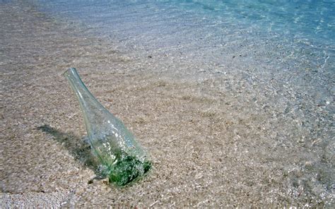 Clear Glass Bottle On Sea Shore Hd Wallpaper Wallpaper Flare