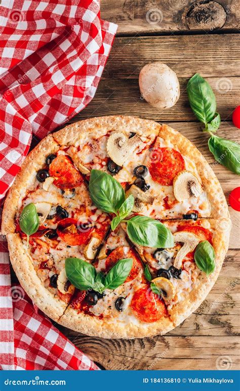 Sliced Italian Pizza With Salami Mozzarella Mushroom Tomatoes Black