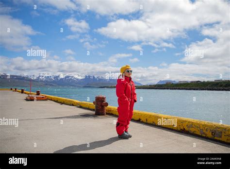 Little Girl In Snow Suit Waiting At Harbor For Boat Dalvik Iceland