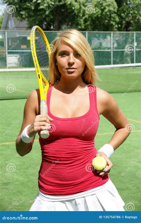 Pretty Young Tennis Player On Court With Racket And Ball Stock Photo