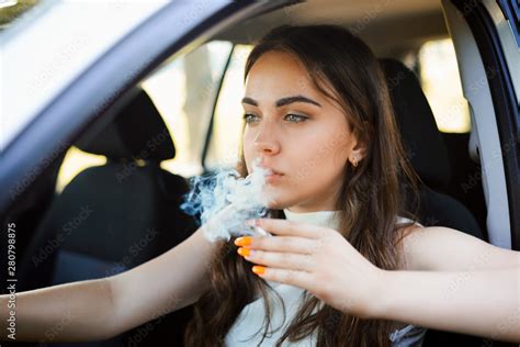 Young Attractive Girl Smoking Cigarette With A Lot Of Smoke While