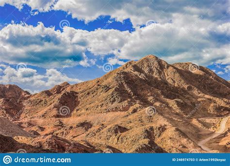 American Desert Landscape Of Rocky Hills And Vibrant Sky And Clouds