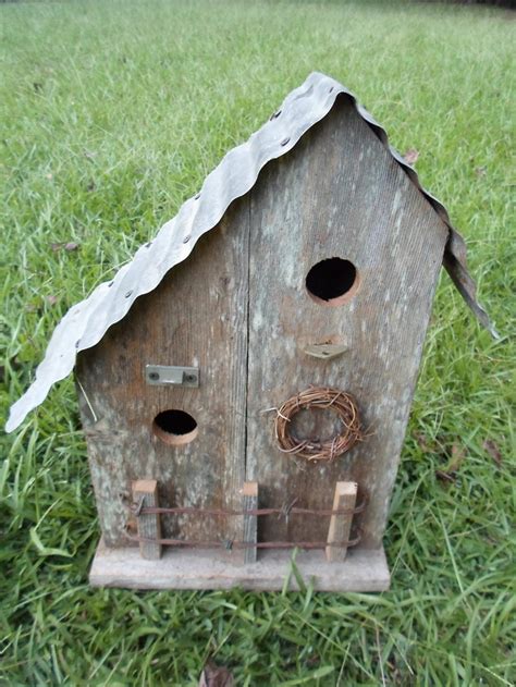 An Old Birdhouse Is Sitting In The Grass