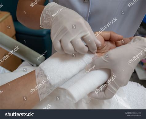Doctor Bandaging Upper Limb Patient After Stock Photo 1235963335