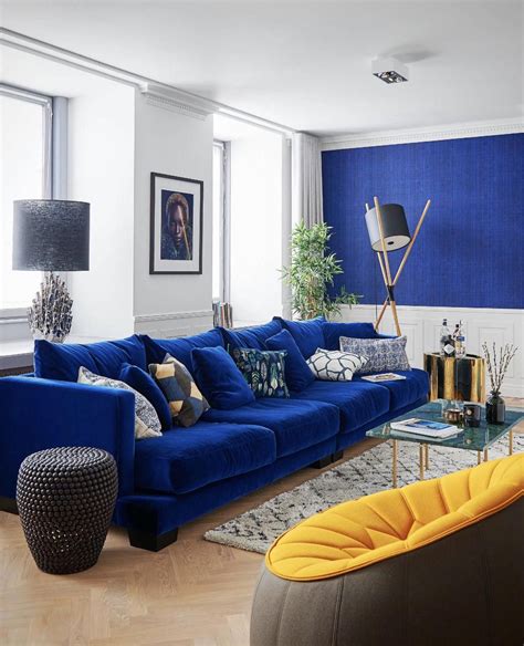 Midcentury Style Living Room With Blue Velvet Sofa And Yellow Chair