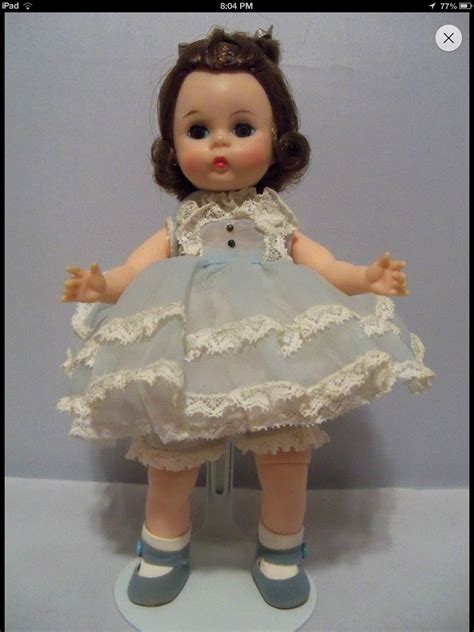 The Doll Is Wearing A Dress And Shoes