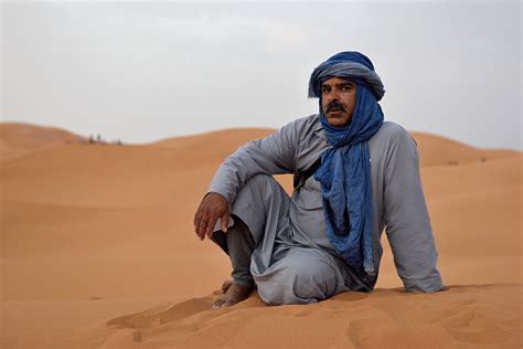 Bedouin Man Wears Traditional Clothing In Sahara Desert Stock Photo