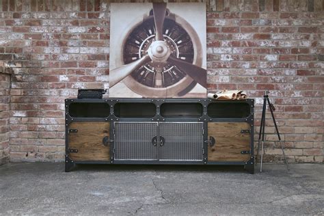 An Old Fashioned Television Stand In Front Of A Brick Wall With A Clock